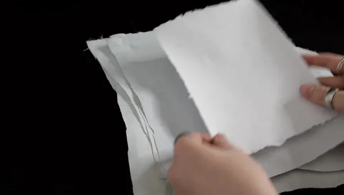 Peel and flatten: Once dry, carefully peel the paper from the cloth. Flatten the sheets using a book press or heavy objects for a day or two.