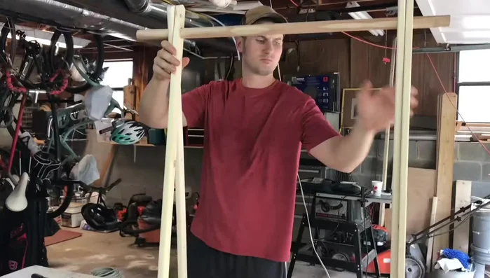 Install dowel rod: Insert the dowel rod through the holes drilled in the leg supports.