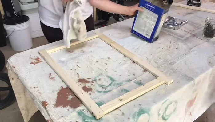 Add rope design (optional): Weave rope around the bottom shelf to create a decorative design. Secure the rope with staples.