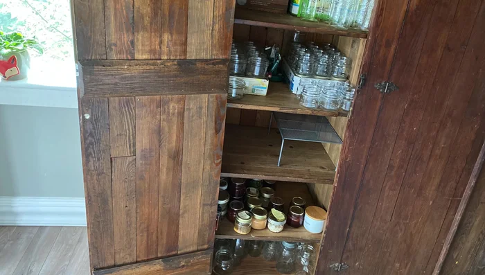 Organize and arrange your storage items inside the repurposed wardrobe.