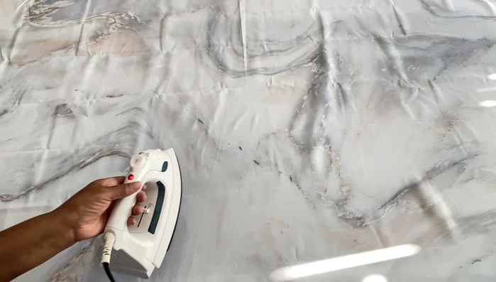 Prepare the shower curtain: Iron or steam to remove wrinkles.