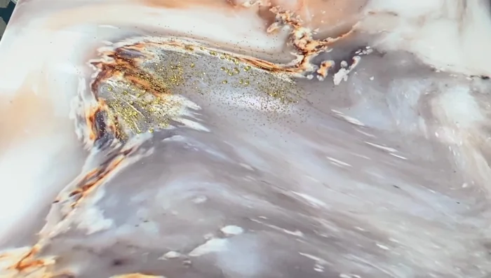 Remove excess glitter: Gently tap off any loose glitter after drying.