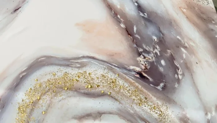 Remove excess glitter: Gently tap off any loose glitter after drying.