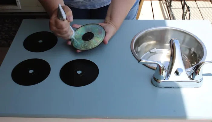 Install a clearance faucet from Lowe's, cutting holes and bolting it in from underneath.