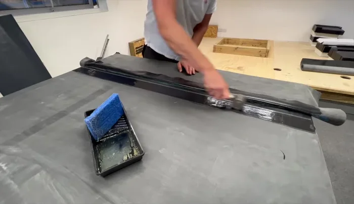 Use the seam tape roller to bond the seam tape to the primer, rolling along the length and sides.