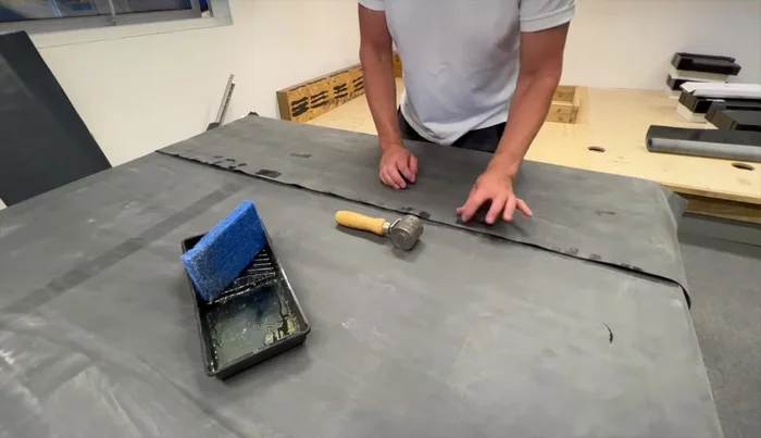 Roll down the primed lap into the seam tape using the seam roller.