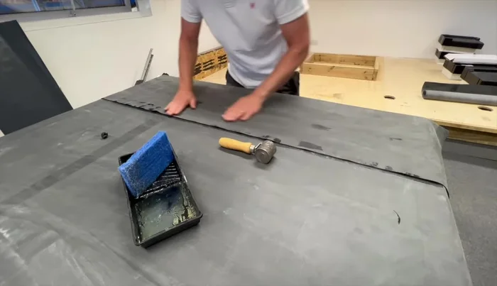 Roll down the primed lap into the seam tape using the seam roller.