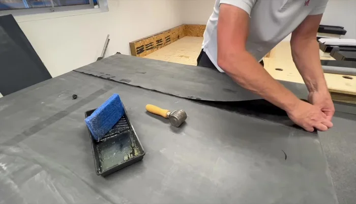 Roll down the primed lap into the seam tape using the seam roller.