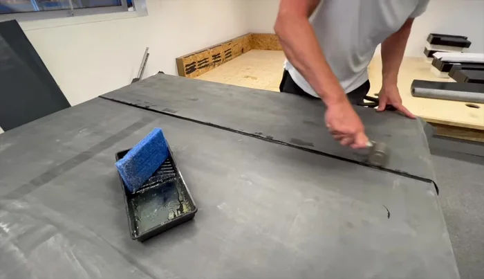 Roll down the primed lap into the seam tape using the seam roller.