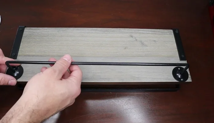 Attach the towel bar (if using) to one of the shelves. Position it slightly back from the front edge for better towel placement.