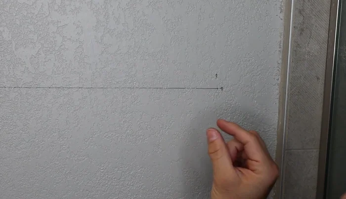 Insert and secure the drywall anchors into the pilot holes (if necessary).