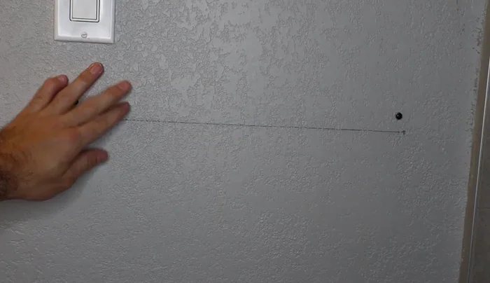 Position the shelf brackets on the wall, ensuring they are level and align with the marks. Partially insert the screws to allow for shelf placement.