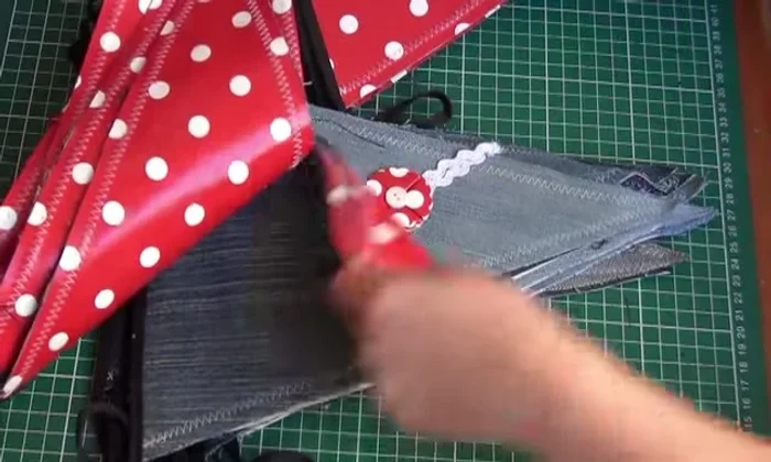 Attach decorations: Attach the finished flowers to the denim banner.