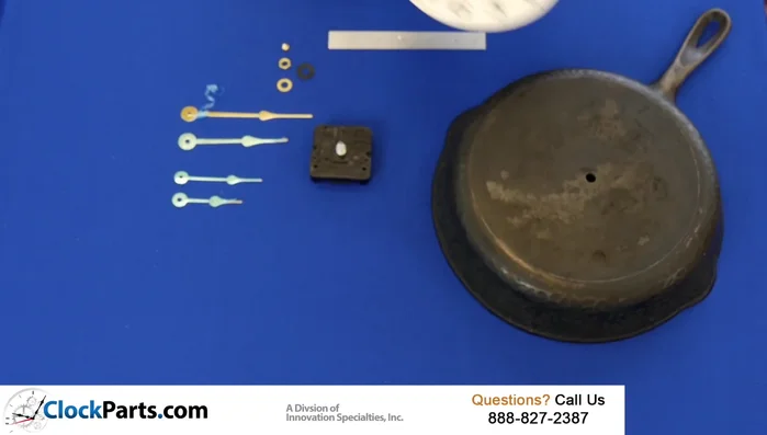 Slide the brass washer over the shaft, then add and tighten the brass hex nut (don't overtighten).