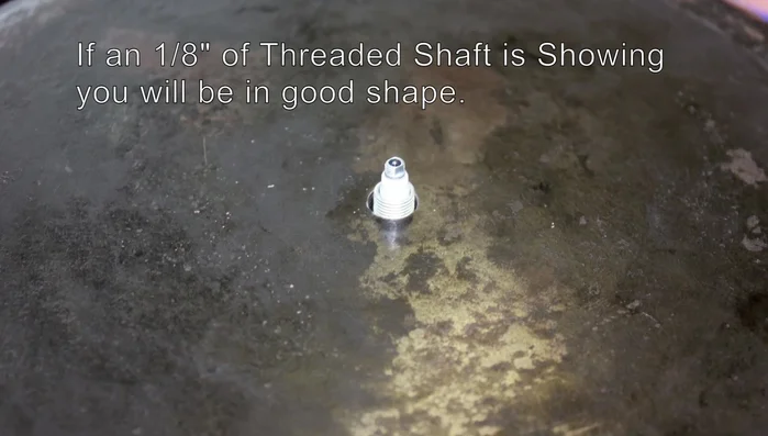 Slide the brass washer over the shaft, then add and tighten the brass hex nut (don't overtighten).