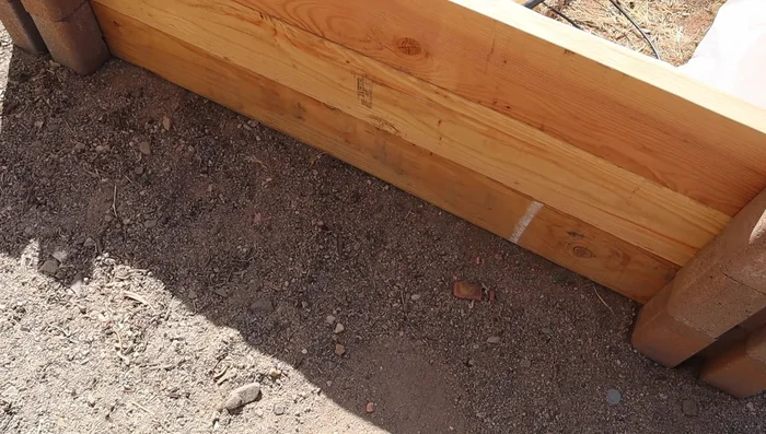 Install drip irrigation tubing (optional, but recommended) underground before placing boards.