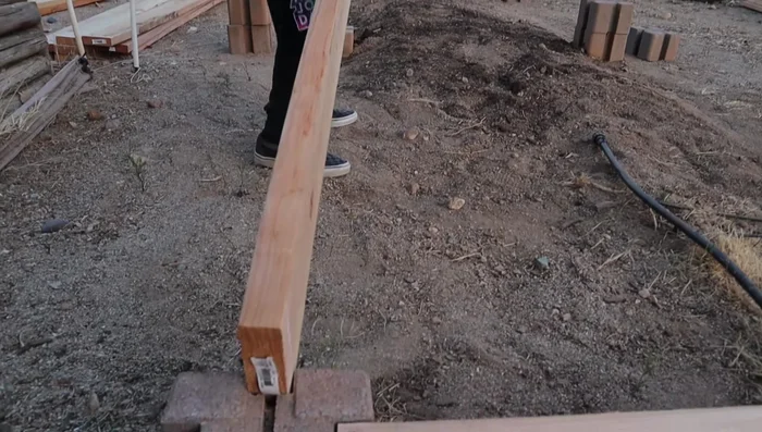 Insert rebar into the holes in each block stack to secure the structure.