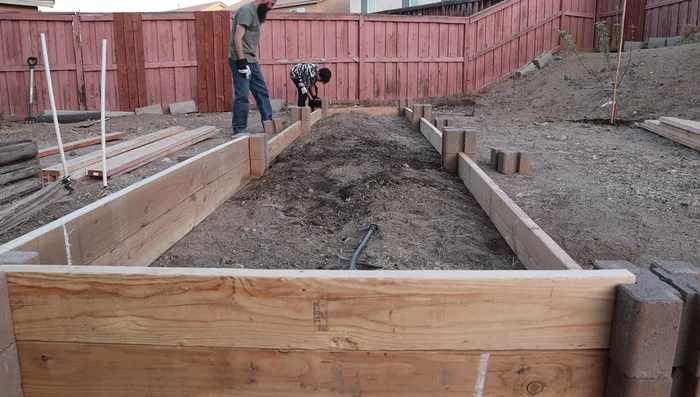 Insert rebar into the holes in each block stack to secure the structure.