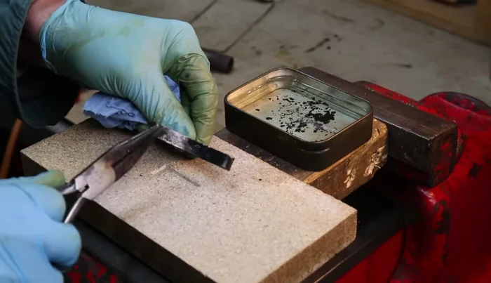 Quench the spring in oil again to complete the tempering process.