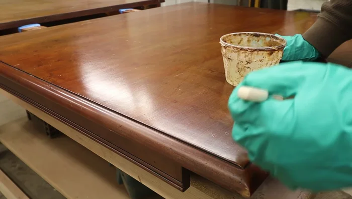 Clean the stripped surface with steel wool and lacquer thinner to ensure complete finish removal.