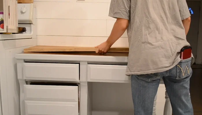 Attach scrap wood to form a countertop.