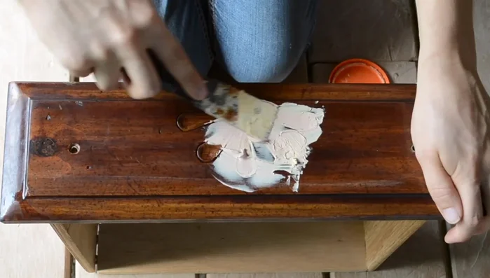 Sand down the filled areas and clean the drawers again.