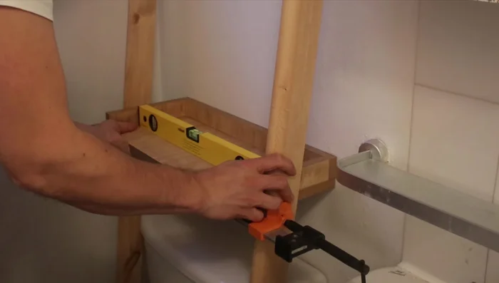 Drill pilot holes to prevent wood splitting. Use another wall for support, ensuring both walls are plumb.