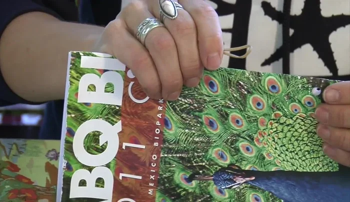 Thread the other end of the rubber band through the second loop to secure the notebook.