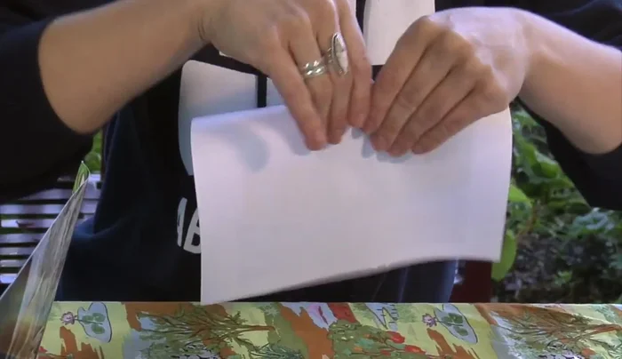 Fold your recycled paper sheets in half.