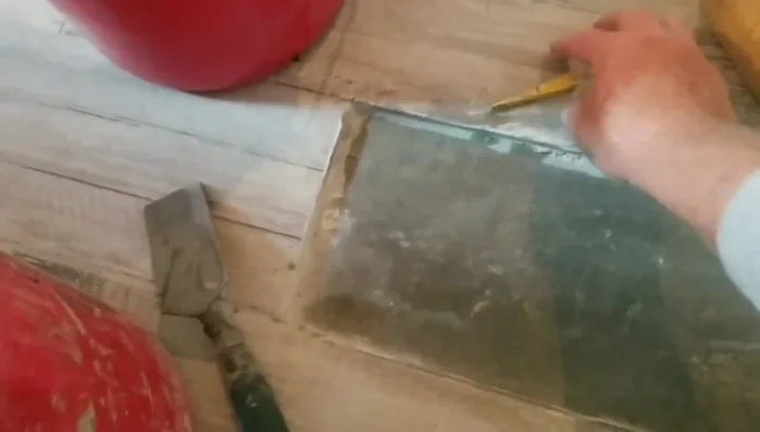 Set the new tile into place, pressing down firmly and ensuring flush alignment with the surrounding tiles. Use spacers between tiles to maintain consistent spacing.