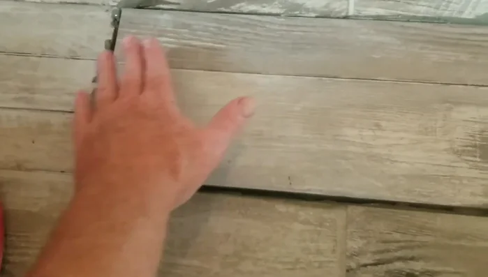 Set the new tile into place, pressing down firmly and ensuring flush alignment with the surrounding tiles. Use spacers between tiles to maintain consistent spacing.