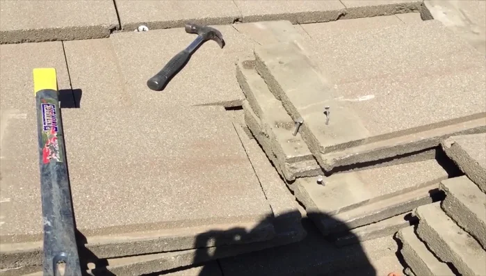 Replace tiles. Carefully replace the tiles, ensuring they are properly aligned and secured with nails.