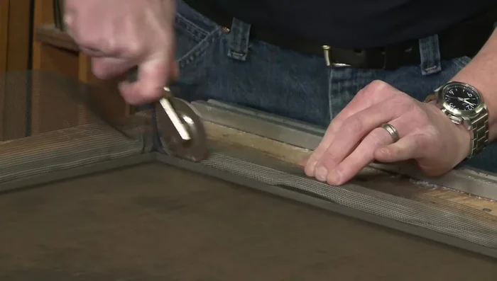 Remove any excess screening by gently tugging it from the top.