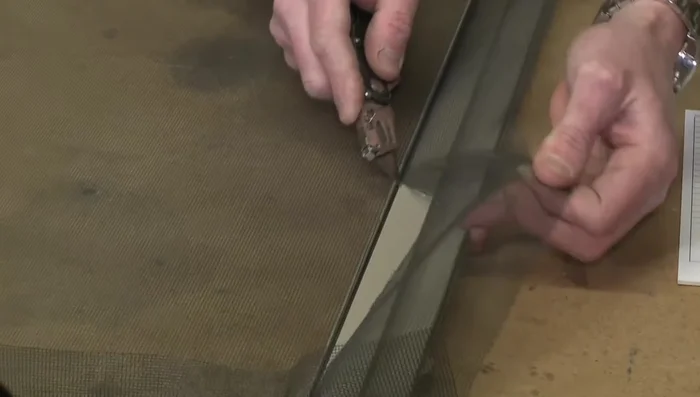 Remove any excess screening by gently tugging it from the top.