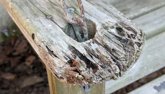 Sand the wood filler to match the swing's shape, using 80 grit sandpaper initially, then fine-tune with a hand sander and 180 grit sandpaper.