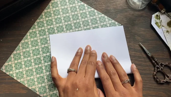 Glue the cover pages to the text block. Place a sheet of paper under the first page to protect it from glue leakage.