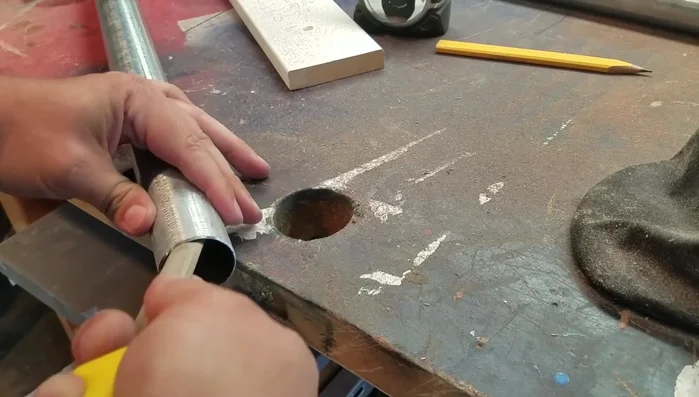 Drill a pilot hole at the center mark of each pipe.