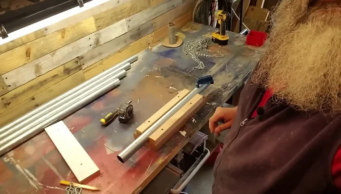 Drill a pilot hole at the center mark of each pipe.