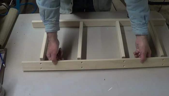 Assemble the pot rack: Screw the side pieces to the back piece, applying glue for extra strength. Use clamps to ensure a tight fit.