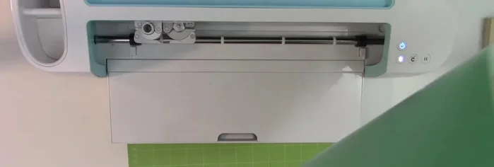 Prepare your vinyl. Load your chosen vinyl onto your cutting mat. Ensure it's smooth and wrinkle-free before loading into the machine.