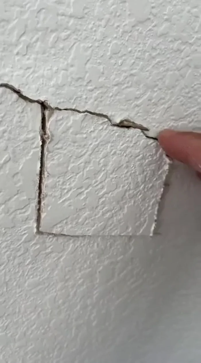 Check for backing behind the drywall crack. Cut a small hole if necessary to confirm.