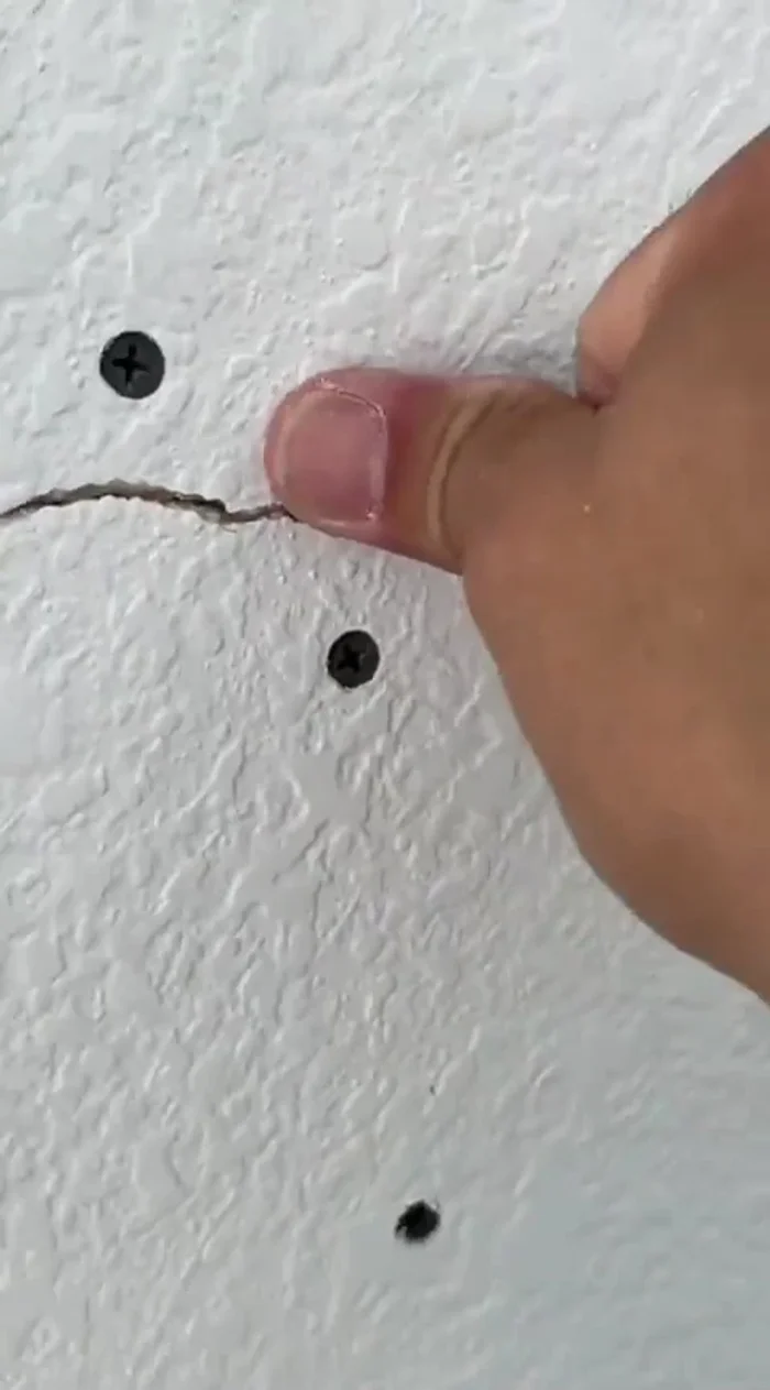 Secure the cracked area with drywall screws, ensuring they're not too deep (about 1/16 inch).