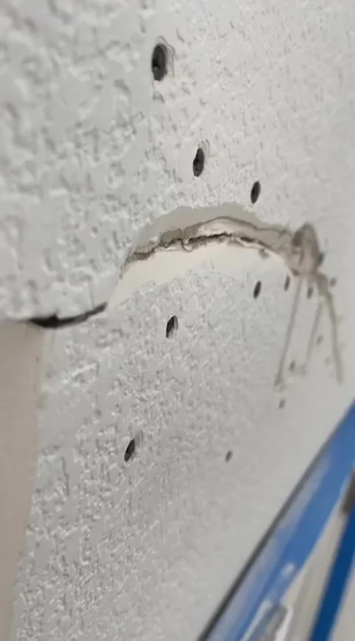 Cut a small valley along the crack using a utility blade to help the joint compound penetrate.