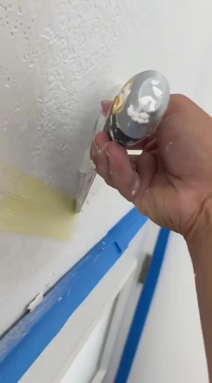 Apply a generous layer of joint compound, ensuring the mesh tape is completely covered and the surface is smooth. Wipe edges with a wet rag for better blending.