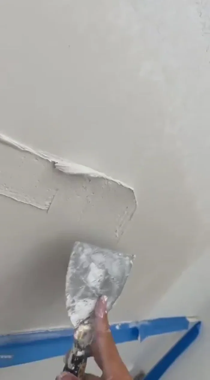 Apply a generous layer of joint compound, ensuring the mesh tape is completely covered and the surface is smooth. Wipe edges with a wet rag for better blending.