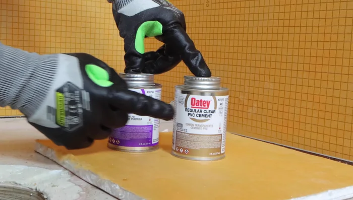 Apply PVC cement to the drain pipe and fitting, then connect, twisting a quarter turn to ensure a secure seal.