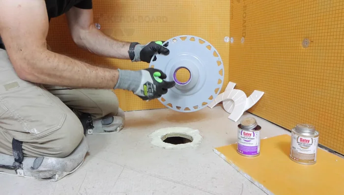 Apply PVC cement to the drain pipe and fitting, then connect, twisting a quarter turn to ensure a secure seal.