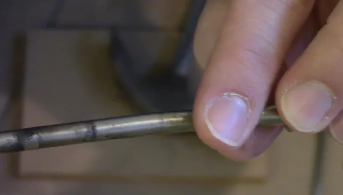 Reinsert the pin: Put the bent pin back into the hinge.