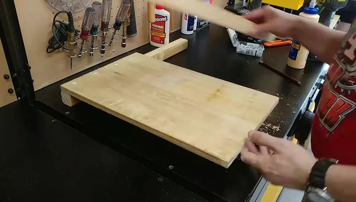 Create the center support: Attach two smaller pieces (cut from remaining boards) to the inside of the ends to provide additional support, creating a divider.