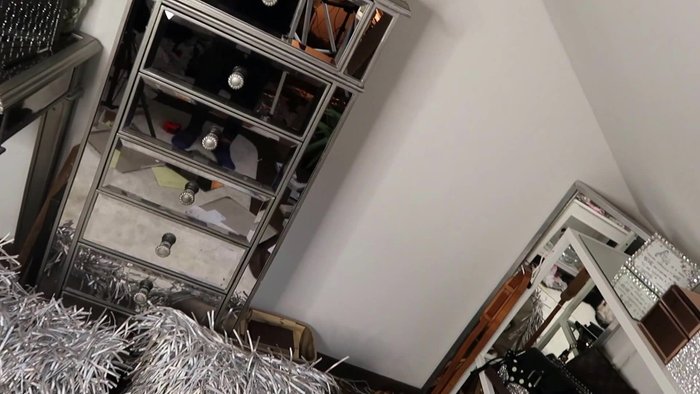 Add a multi-tiered tray on top of a piece of glass to create a wider base for displaying items.